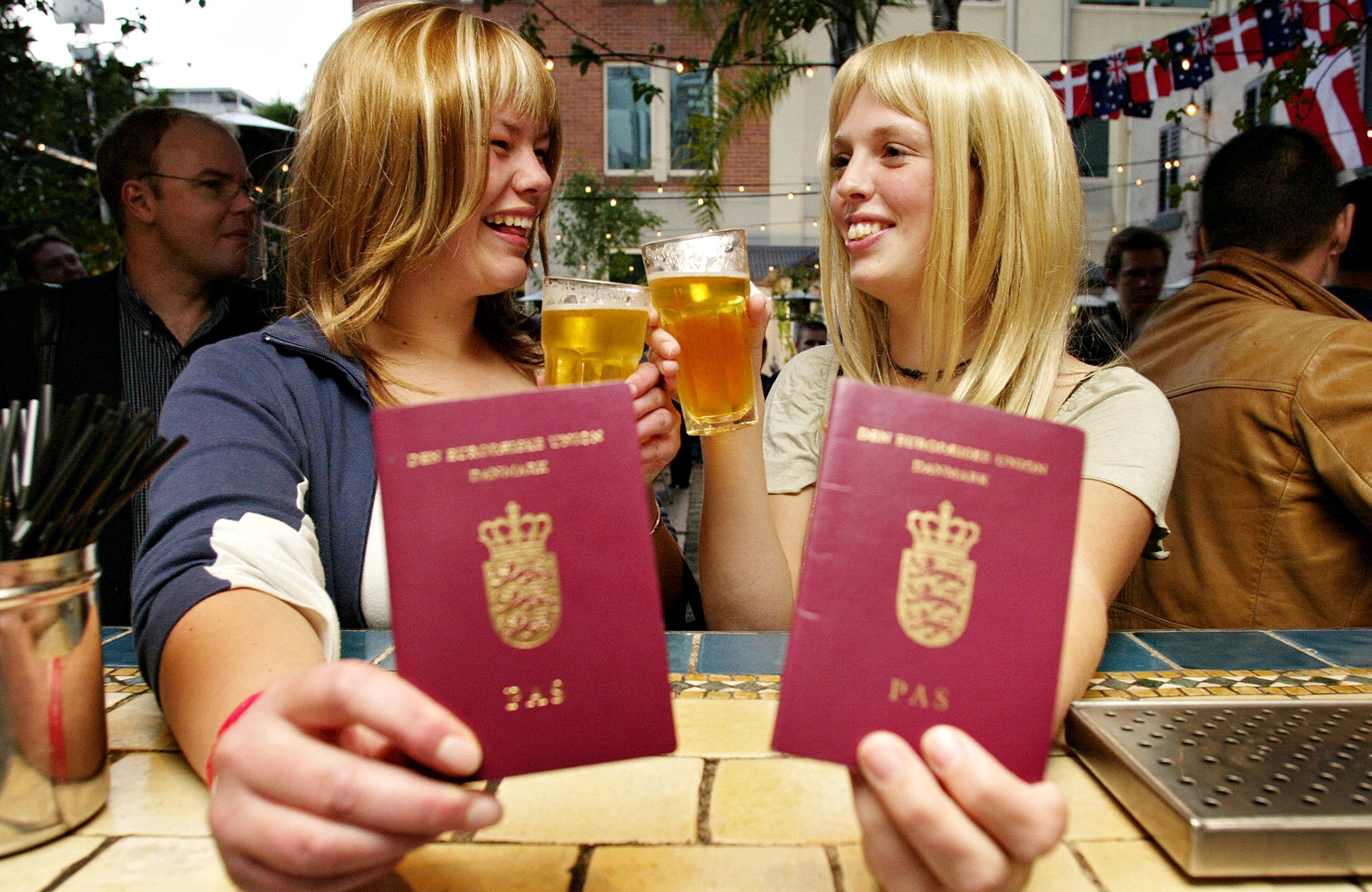 2 European Women Hold Their Native Country Passports for international travel